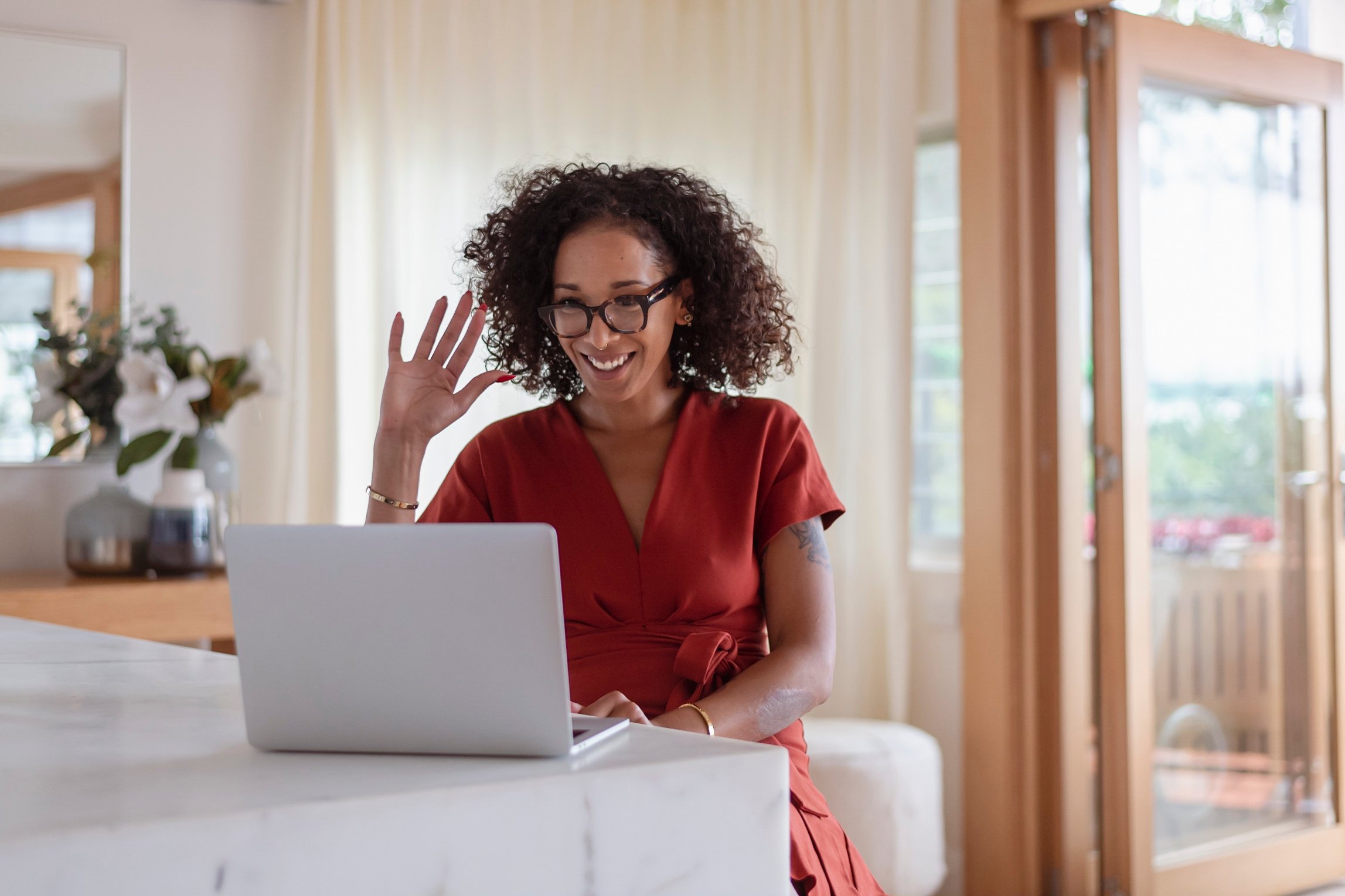 Person using laptop computer in beautiful home.