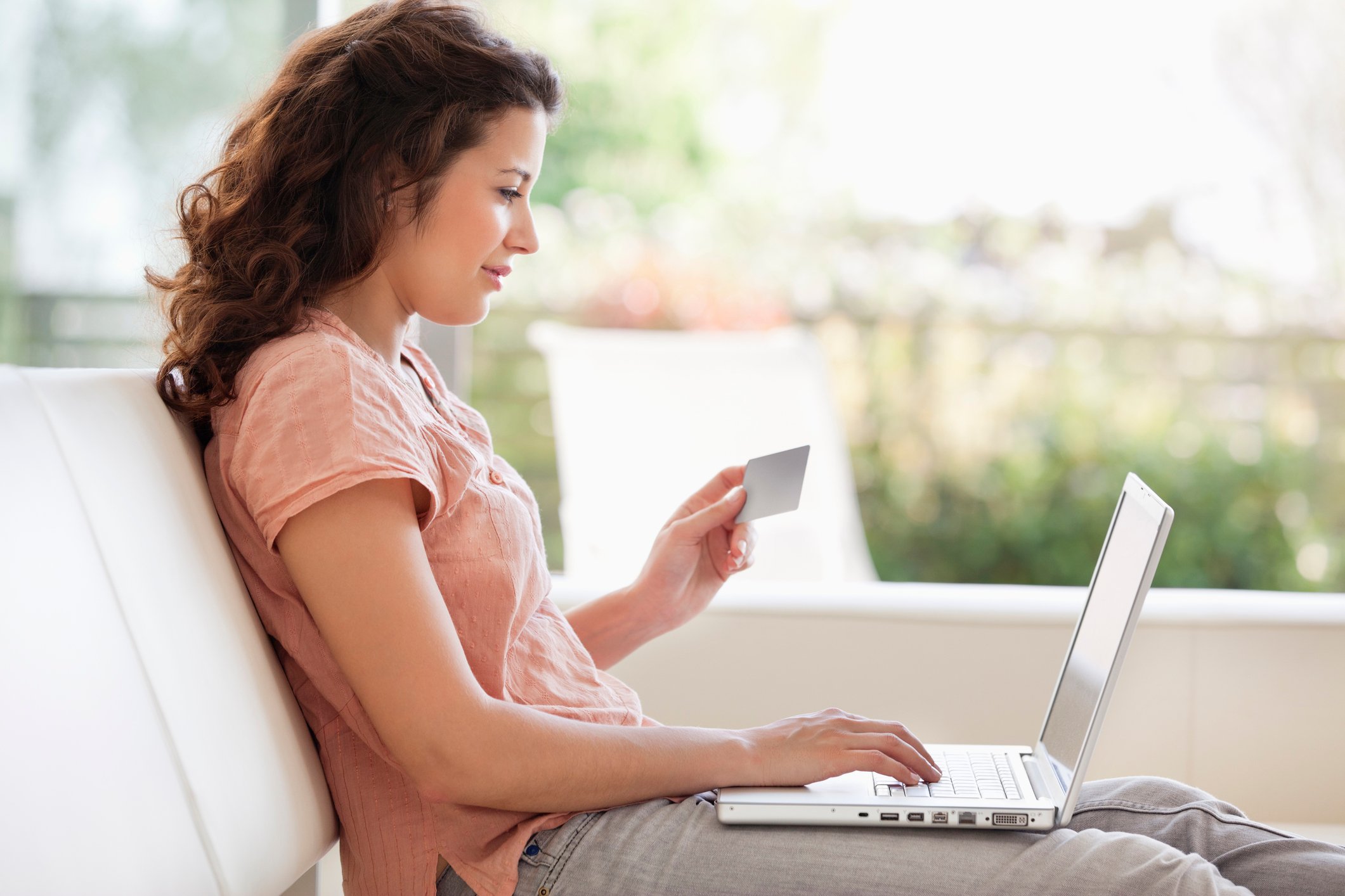 A person making an online purchase on a laptop. 