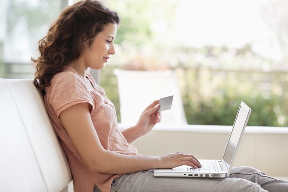 A person making an online purchase on a laptop. 
