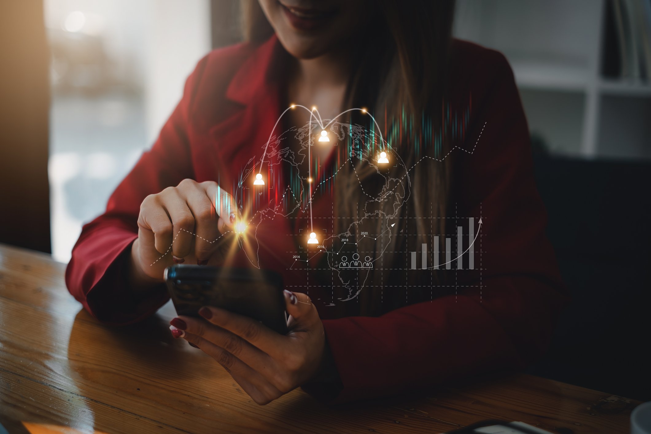 A person touches the screen of their smartphone. An artist's rendering of charts, graphs, and lights is above the phone. 