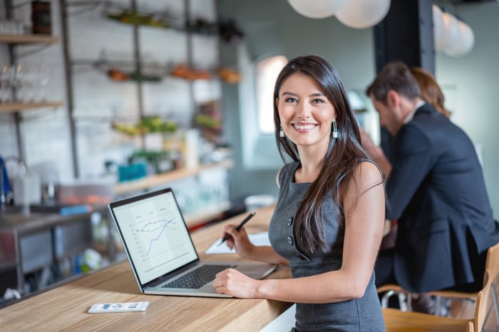 A person checks an investment portfolio on a laptop computer.