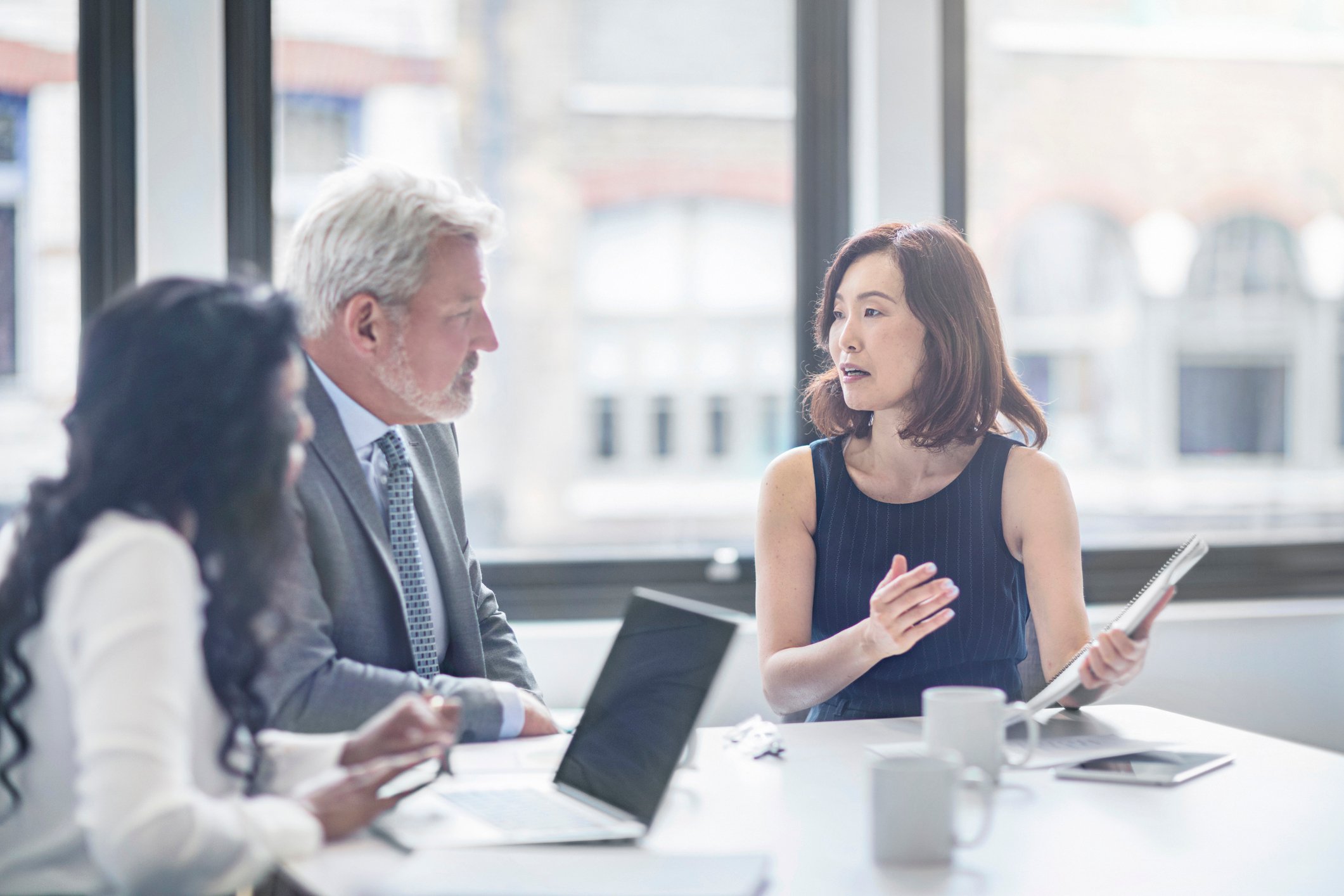 Three people in a meeting.