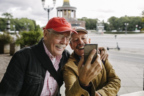 Two older adults taking a selfie.