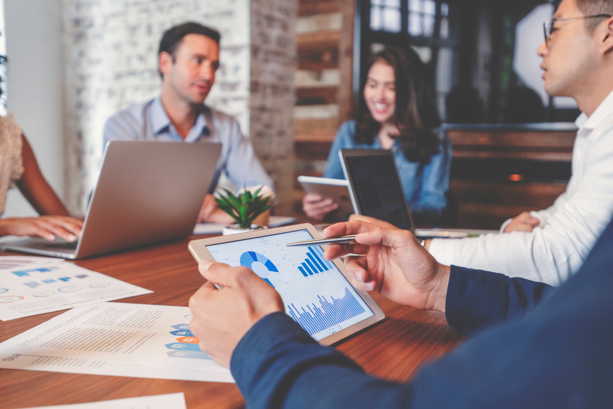 Investors gathered around a table, analyzing financial data.