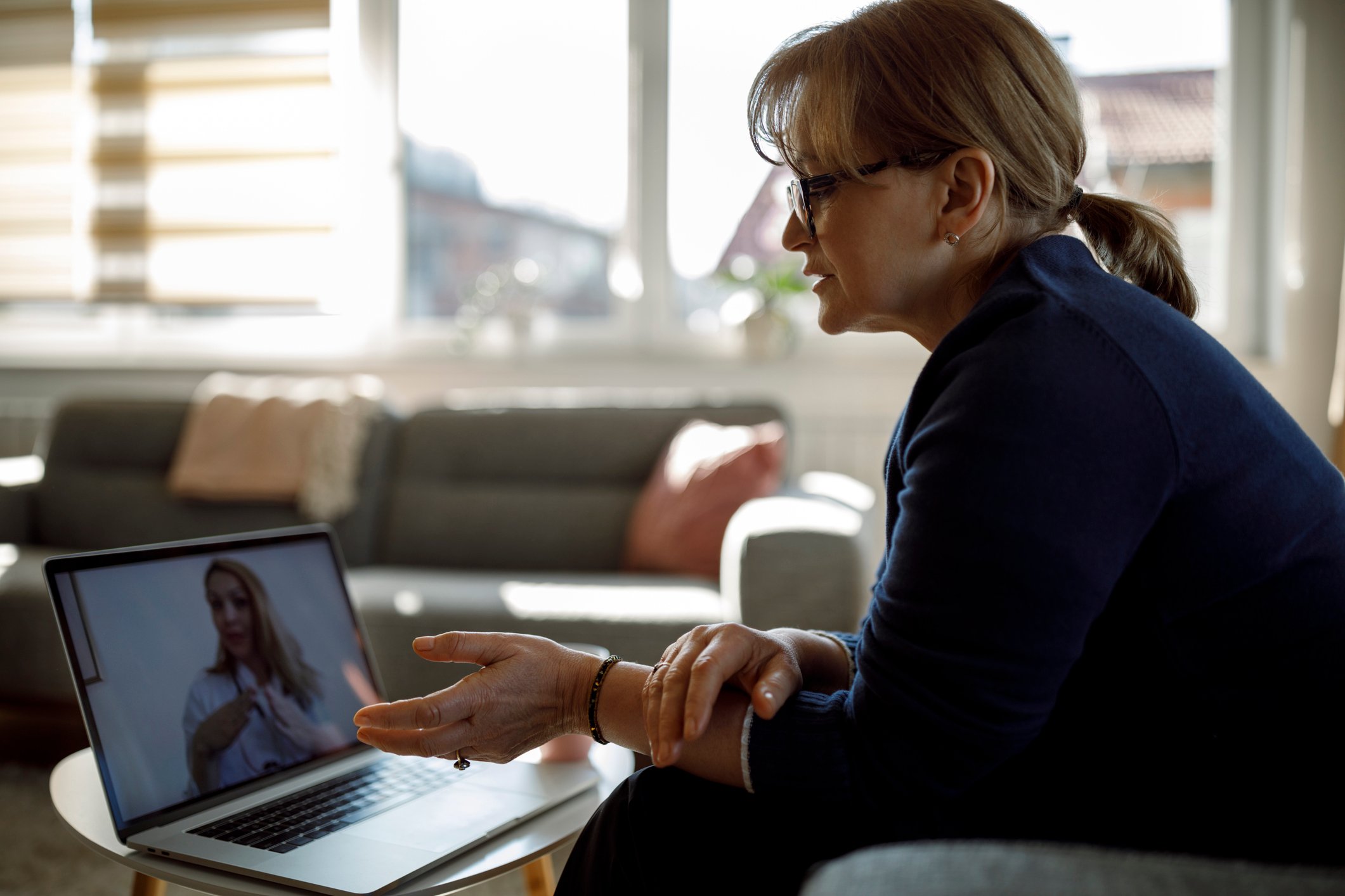 Person talking to a physician through a laptop.