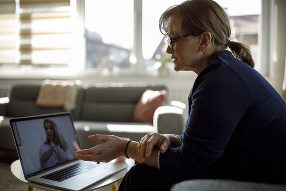 Person talking to a physician through a laptop.