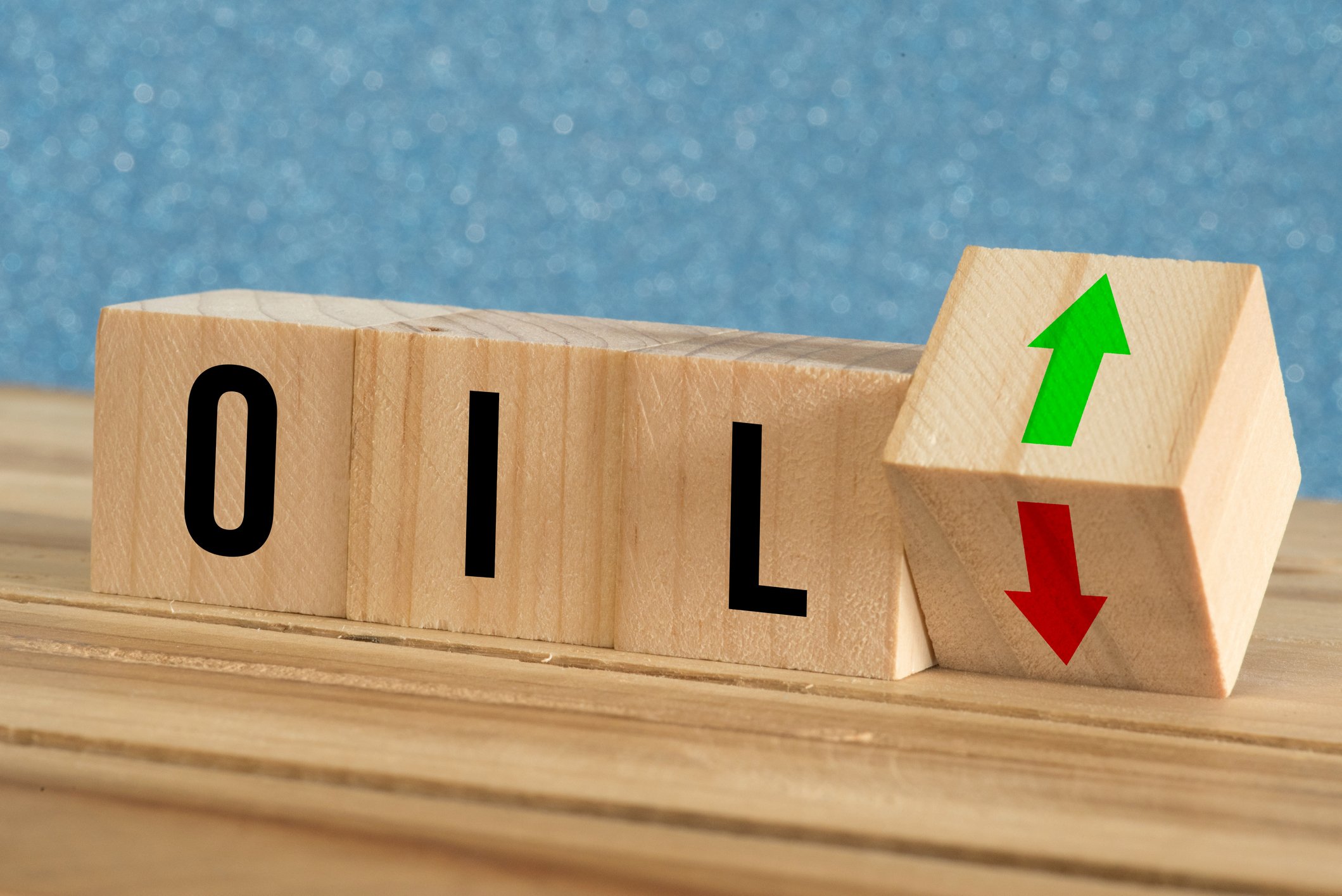 Blocks with letters spelling oil and a block with a down arrow turning to up arrow. 