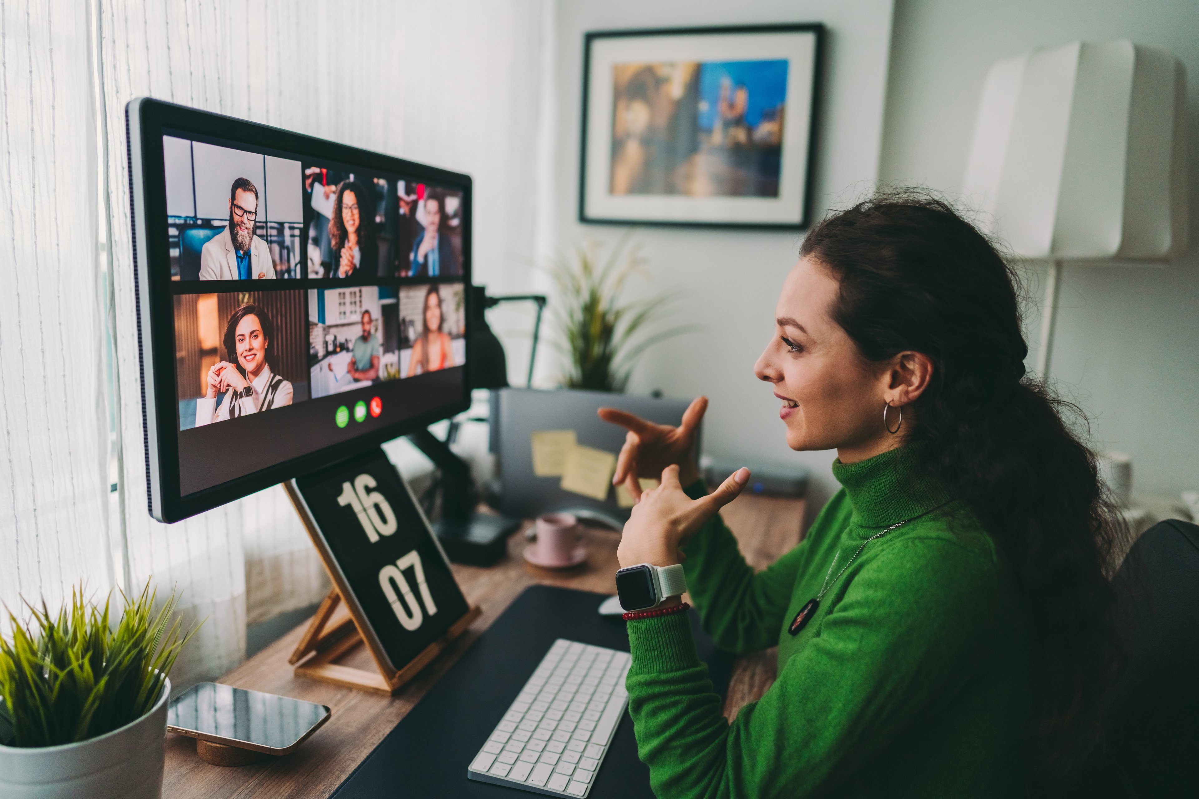 A person using video conferencing on a computer at home.