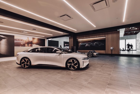 A white Lucid Air electric sedan at a Lucid showroom.