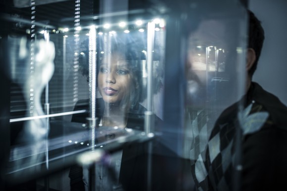 Scientists look at the results of a 3D printer.