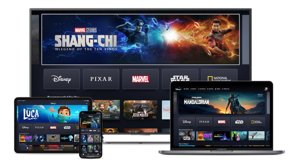 Disney+ homescreen displayed on a tablet, smartphone, TV, and laptop.