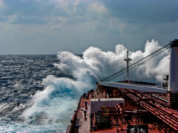 Cargo ship sailing in a choppy sea.