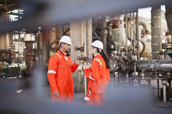 Two workers at an energy facility.