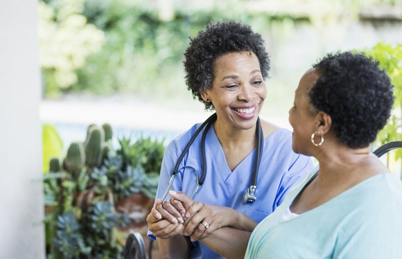An in-home healthcare worker visits a patient.