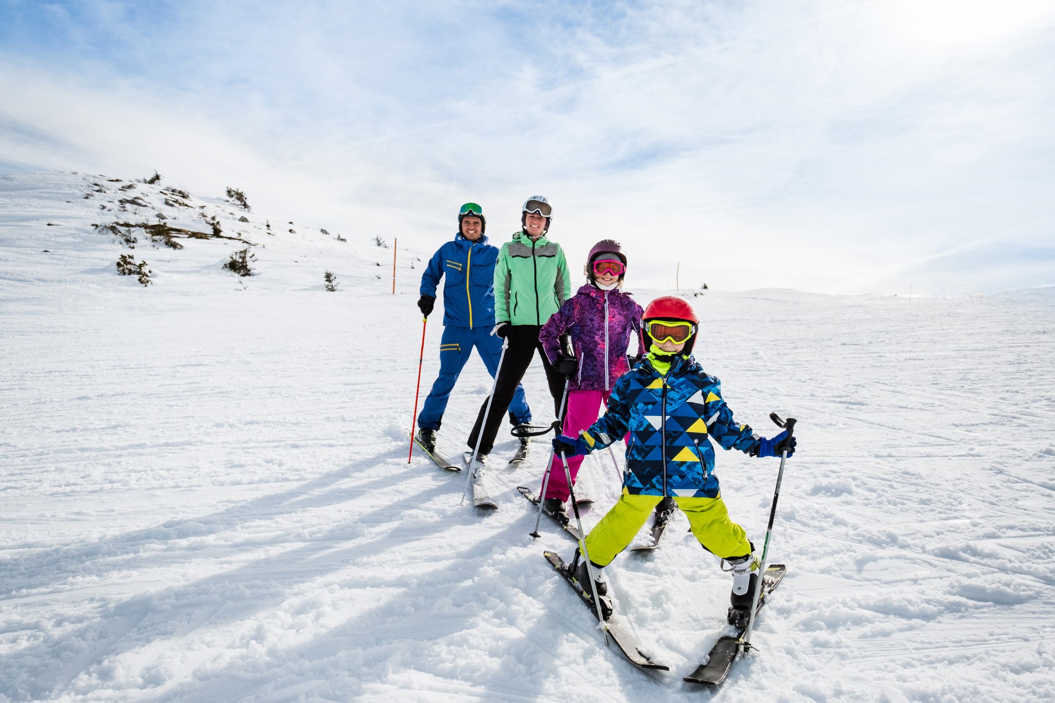 A family on skis having their photo taken.