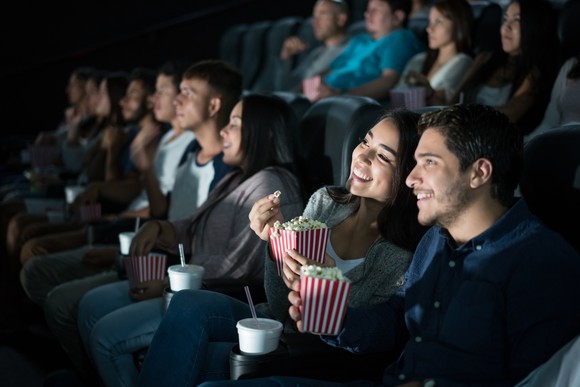 Audience members in a movie theater enjoying a movie.