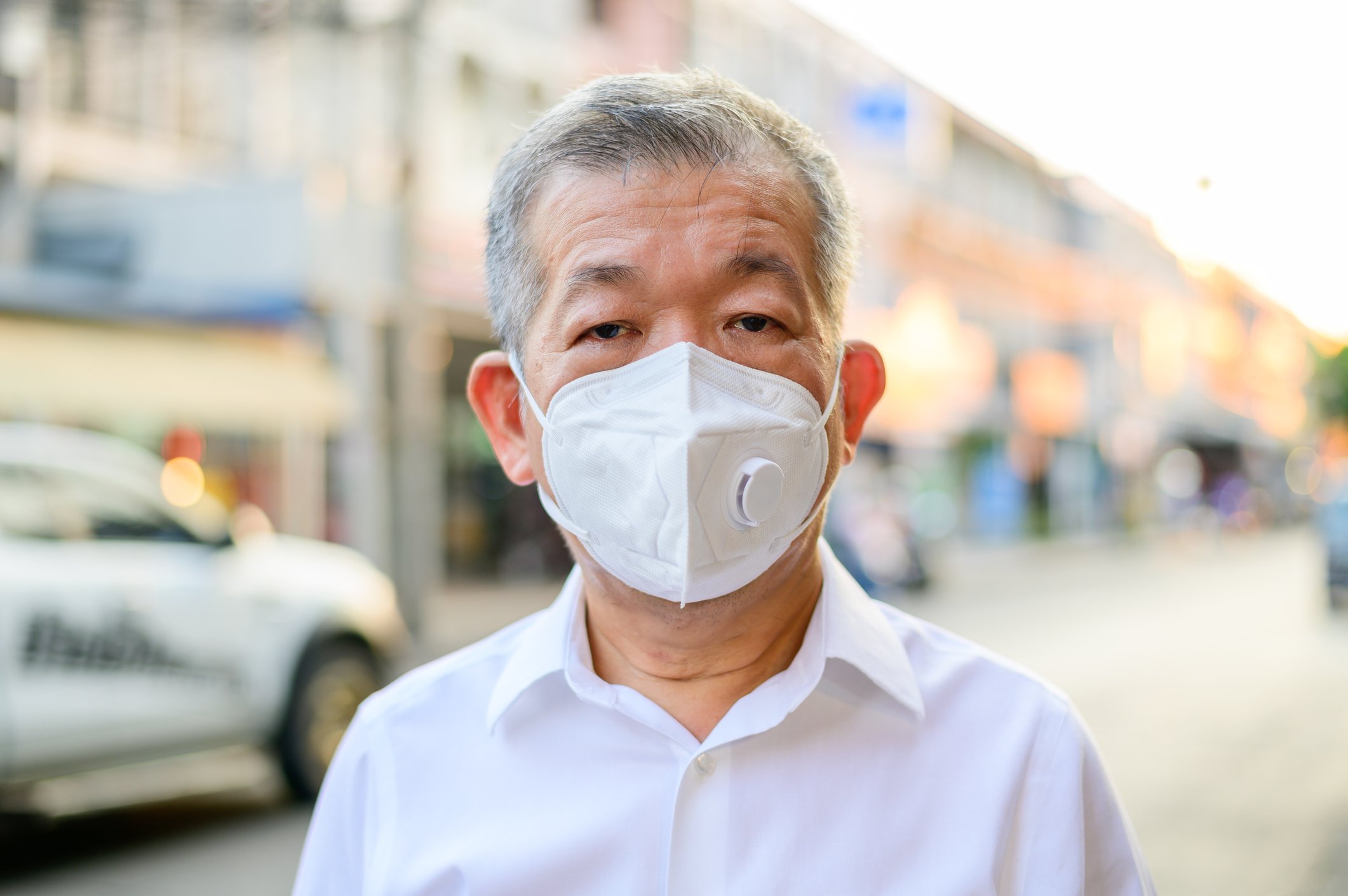 A senior person wearing N95 respirator mask.