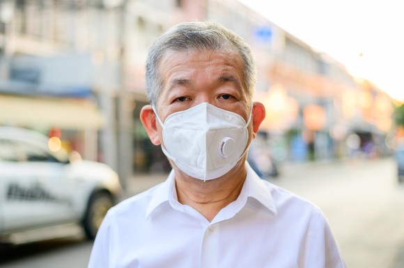 A senior person wearing N95 respirator mask.
