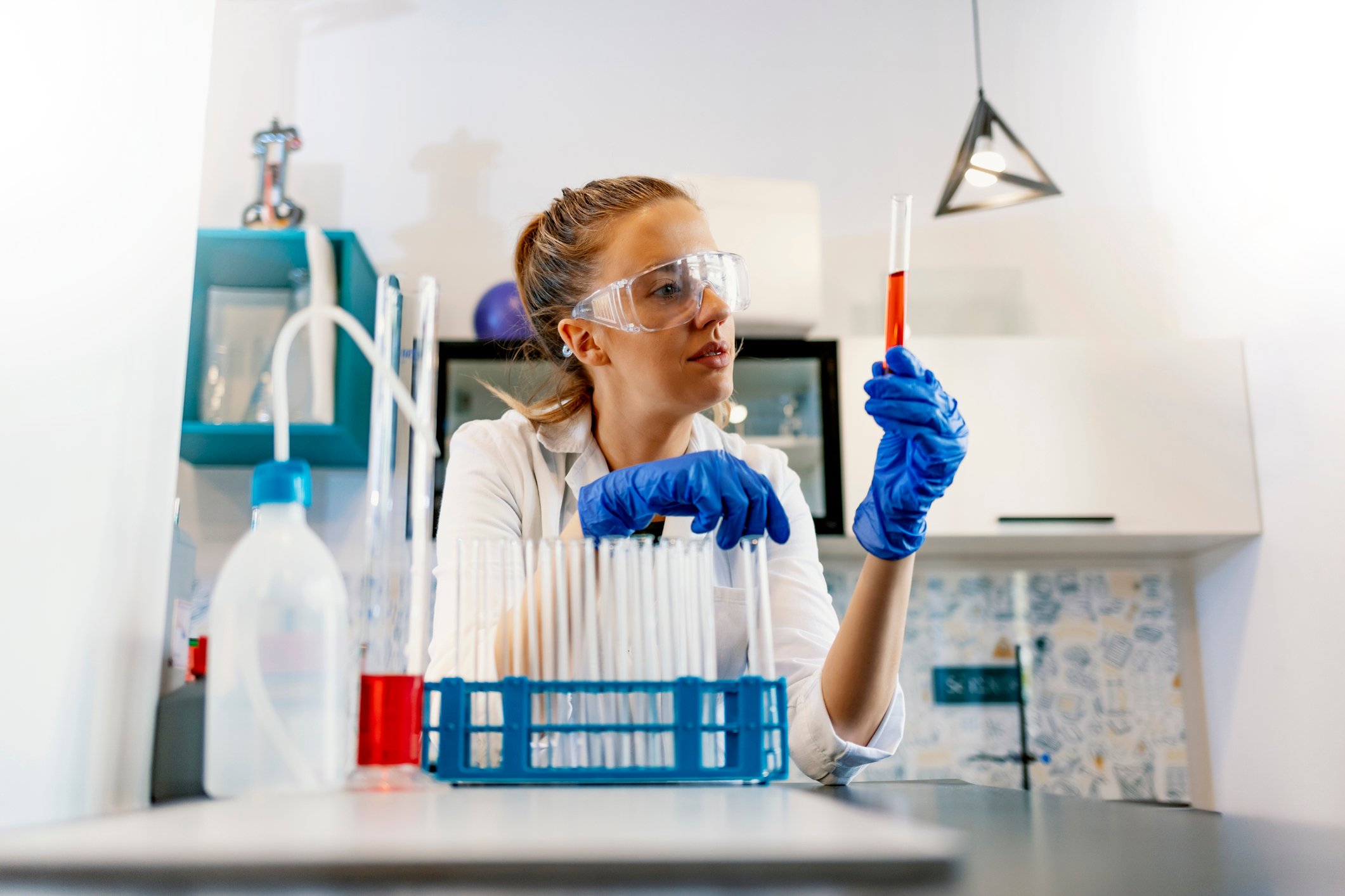 A lab technician looks at a blood sample.
