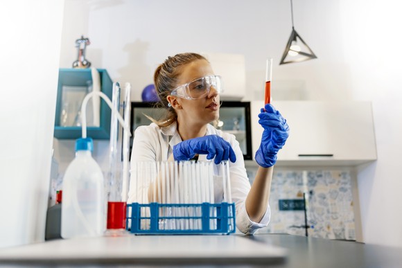 A lab technician looks at a blood sample.