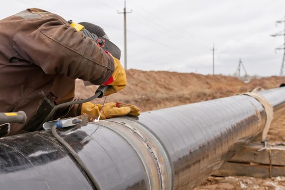 A worker repairing an oil pipeline.
