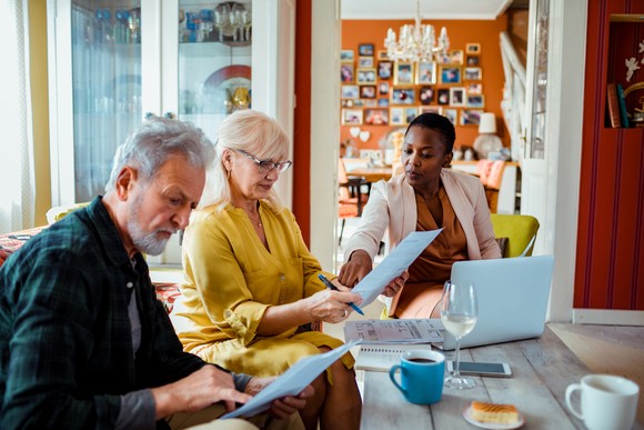 Two older people meeting with a financial advisor. 