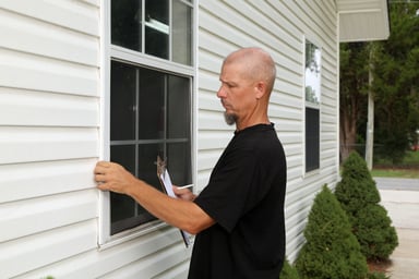 examining windows on a home