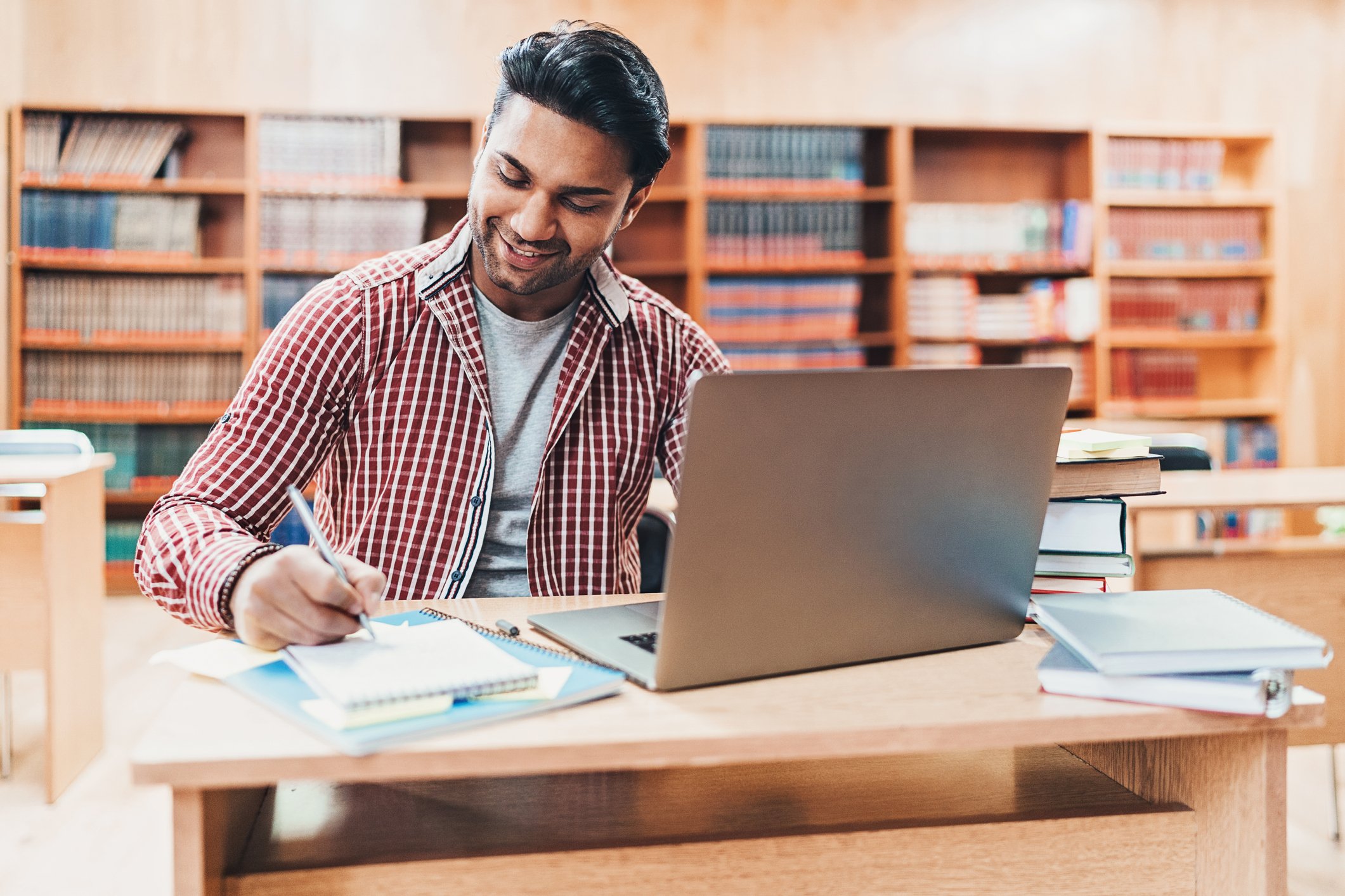 A person doing homework in a library.