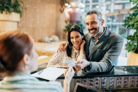 A couple checking into a hotel.