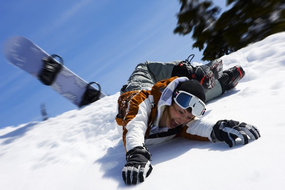 Snowboarder wipes out.