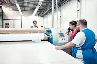workers at machine in textile factory