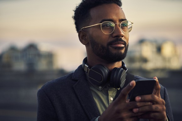 Person using cell phone outdoors.