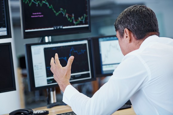 Stressed out investor looking at charts.