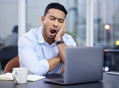 Yawning man, laptop