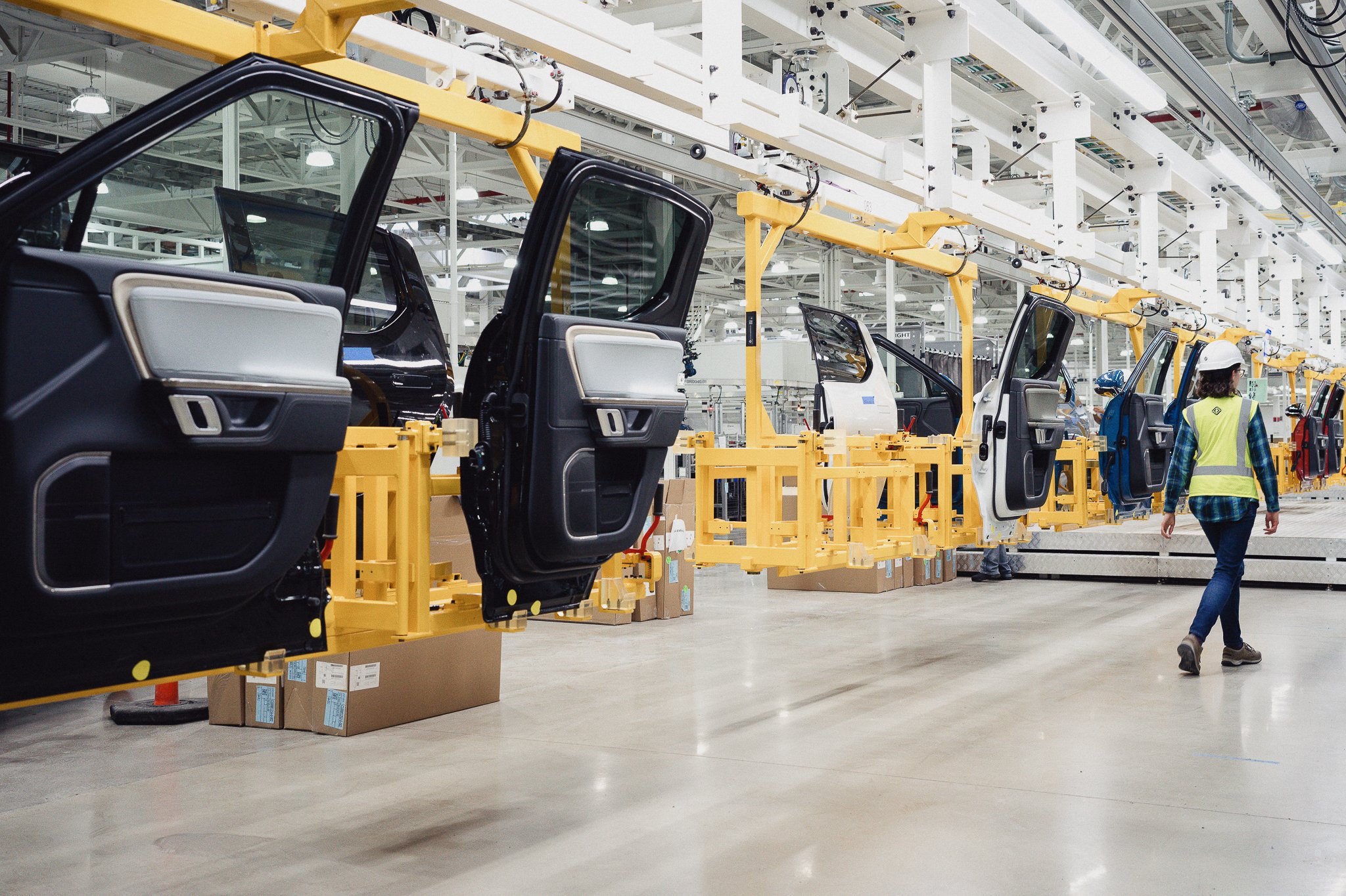 R1T pickup door panels lined up on an assembly line. 