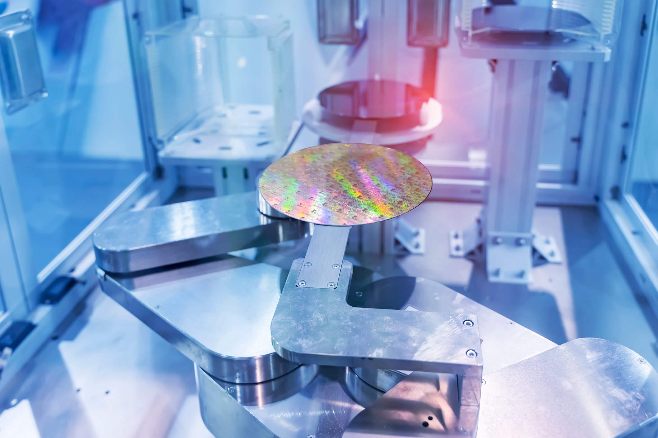 A circular silicon wafer in a semiconductor equipment chamber. 