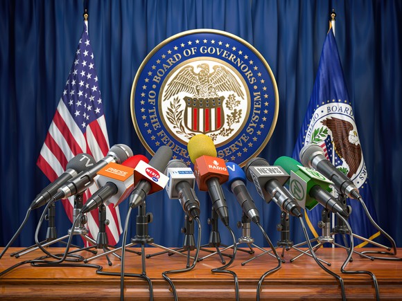 A podium with microphones in front of the Federal Reserve seal.