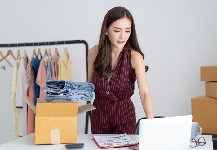 An online merchant prepares to ship clothes.