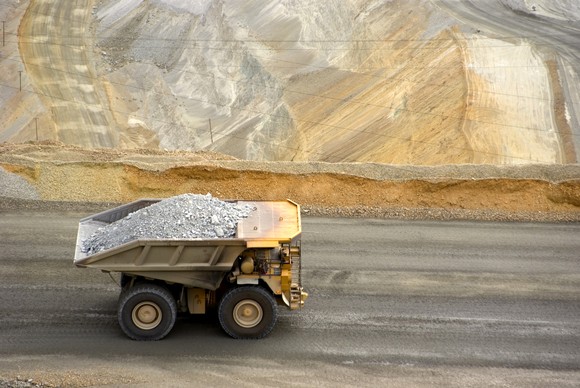 A mining truck carrying a load of ore at an open pit mine.