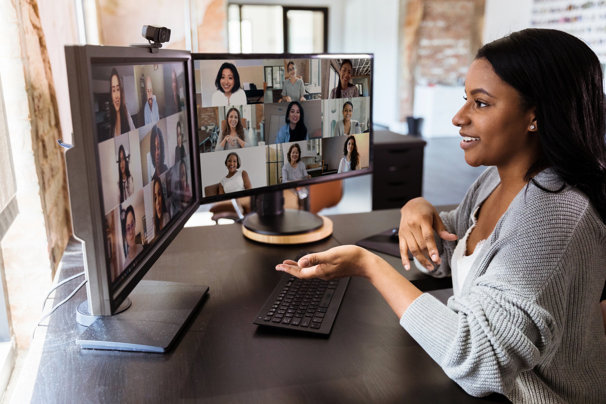 Person seated at a desk, and participating in a video conference.