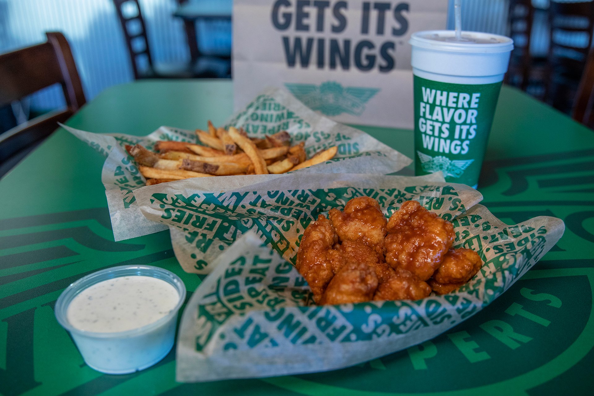 A Wingstop combo meal sits on a table.