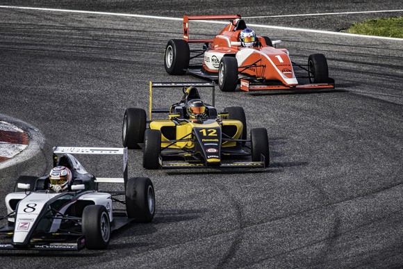 3 race cars circling a track.