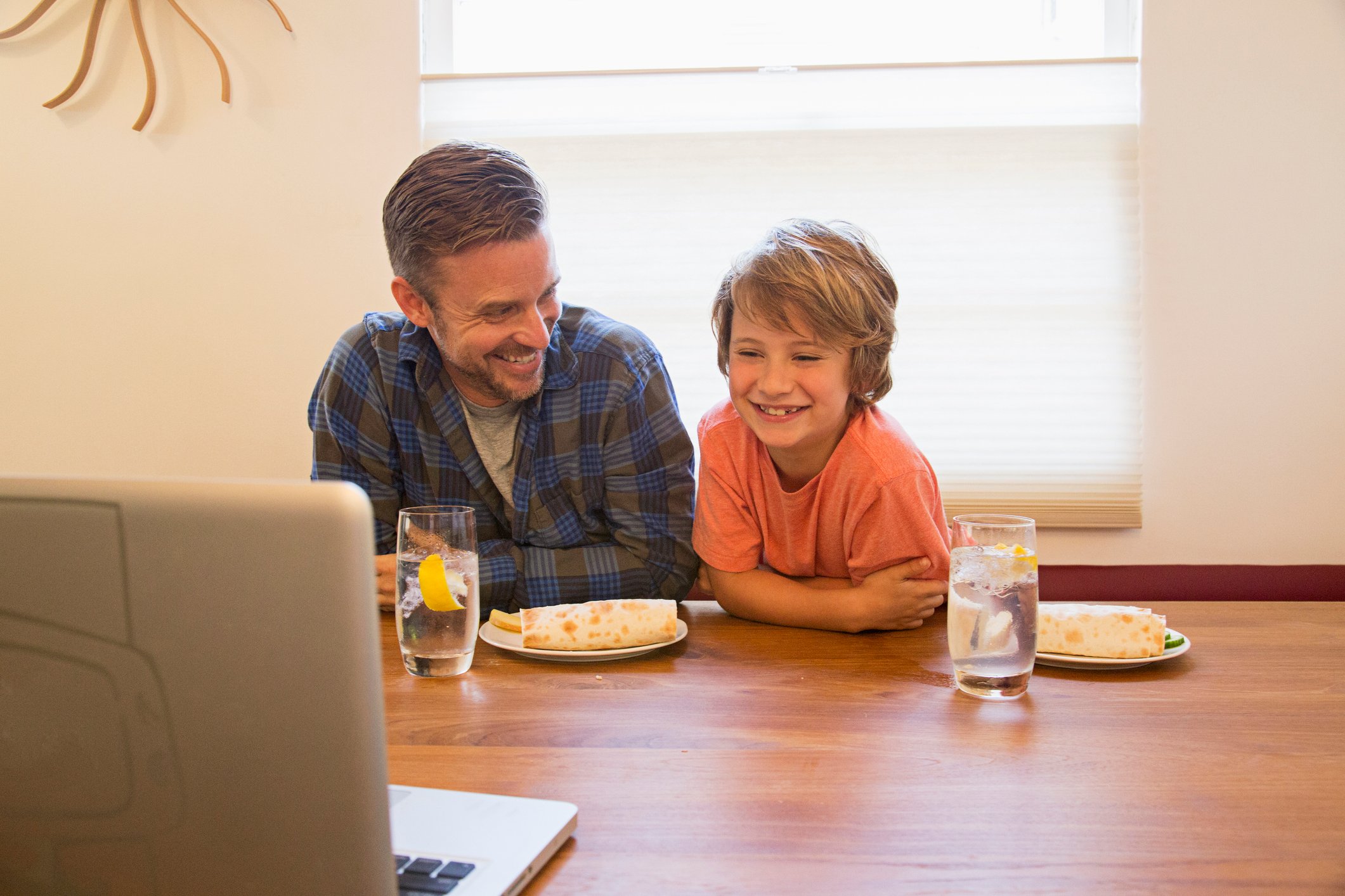 Two people eating burritos.
