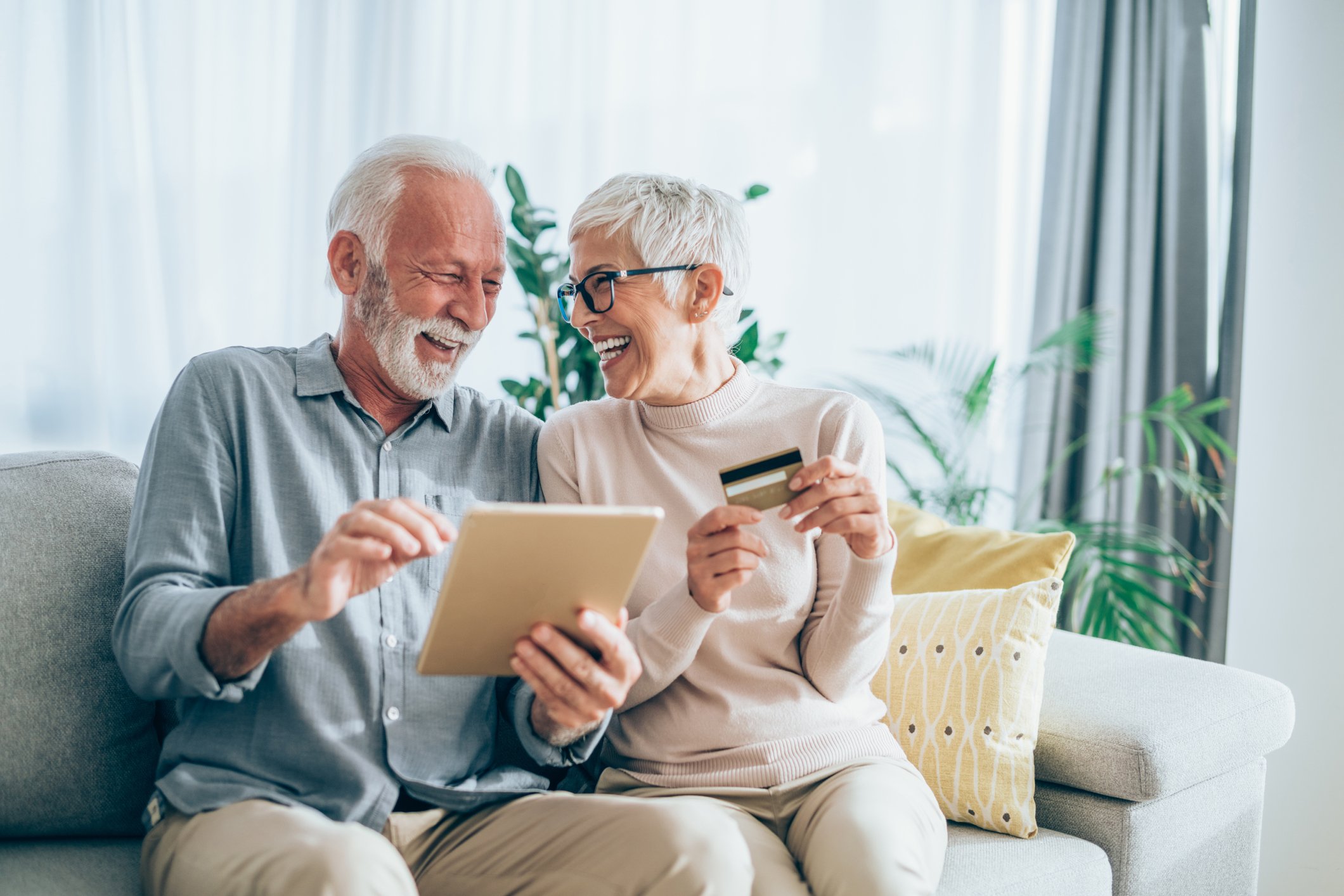 Couple smiling while making online payment