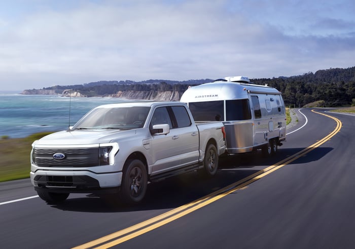 Ford F-150 Lightning towing a trailer.