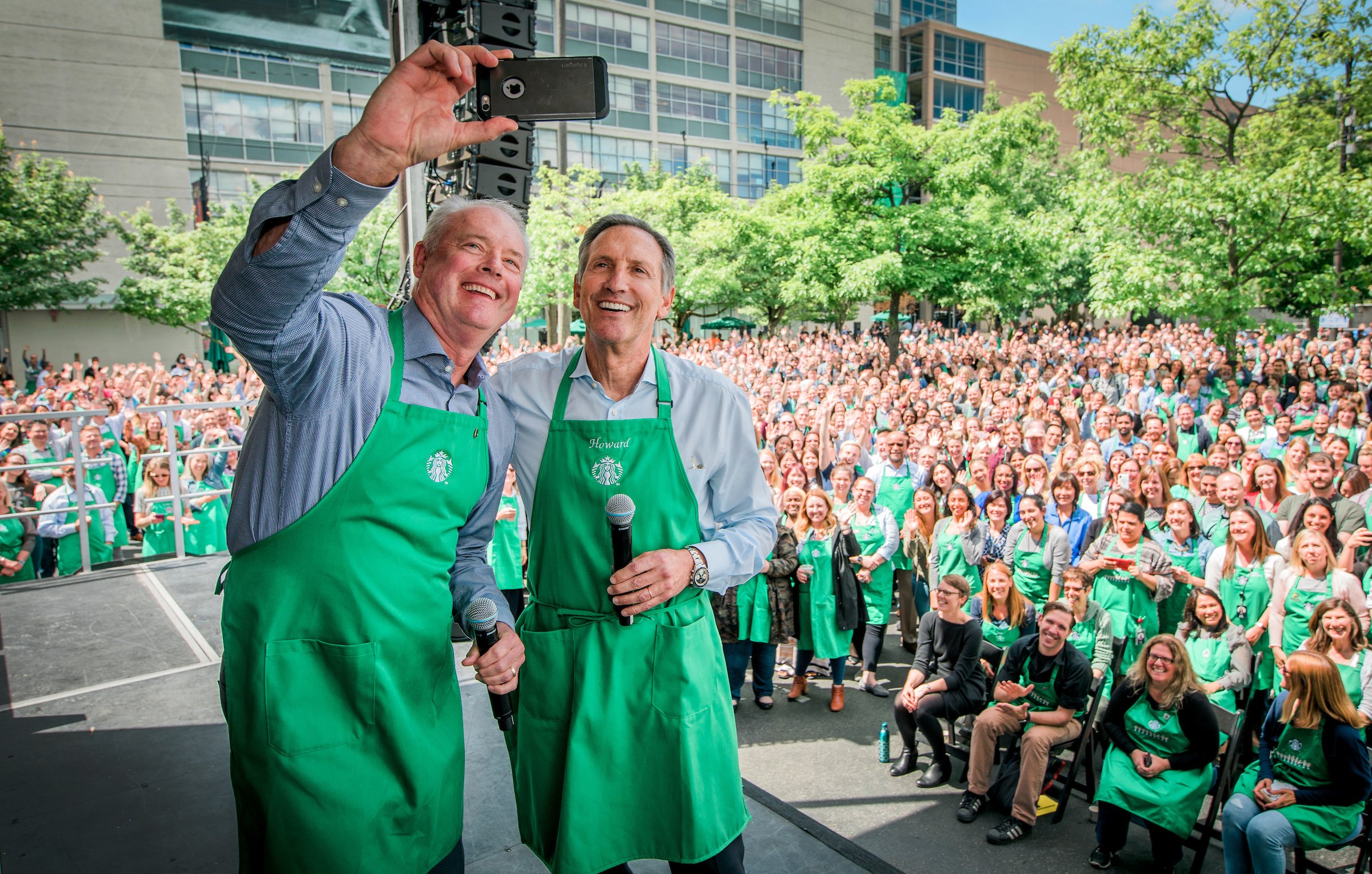 Kevin Johnson and Howard Shultz at  Starbucks event taking a selfie.
