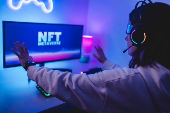 Someone exploring the NFT metaverse on a PC with a headset on.