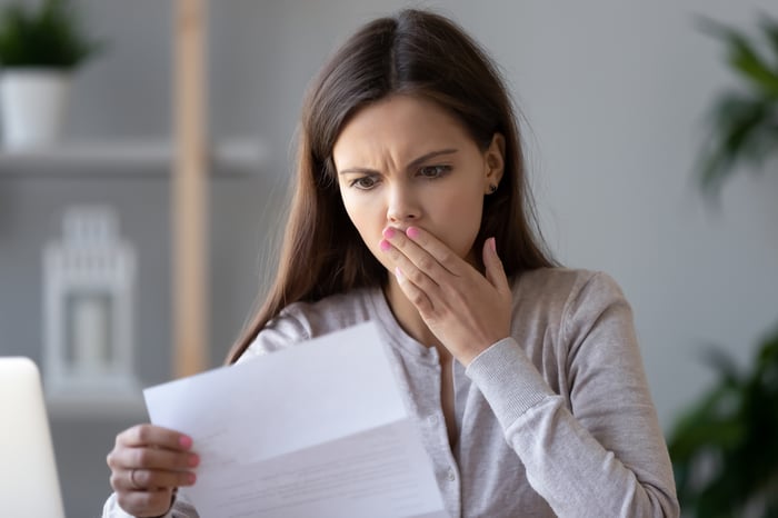 Shocked person reading letter. 