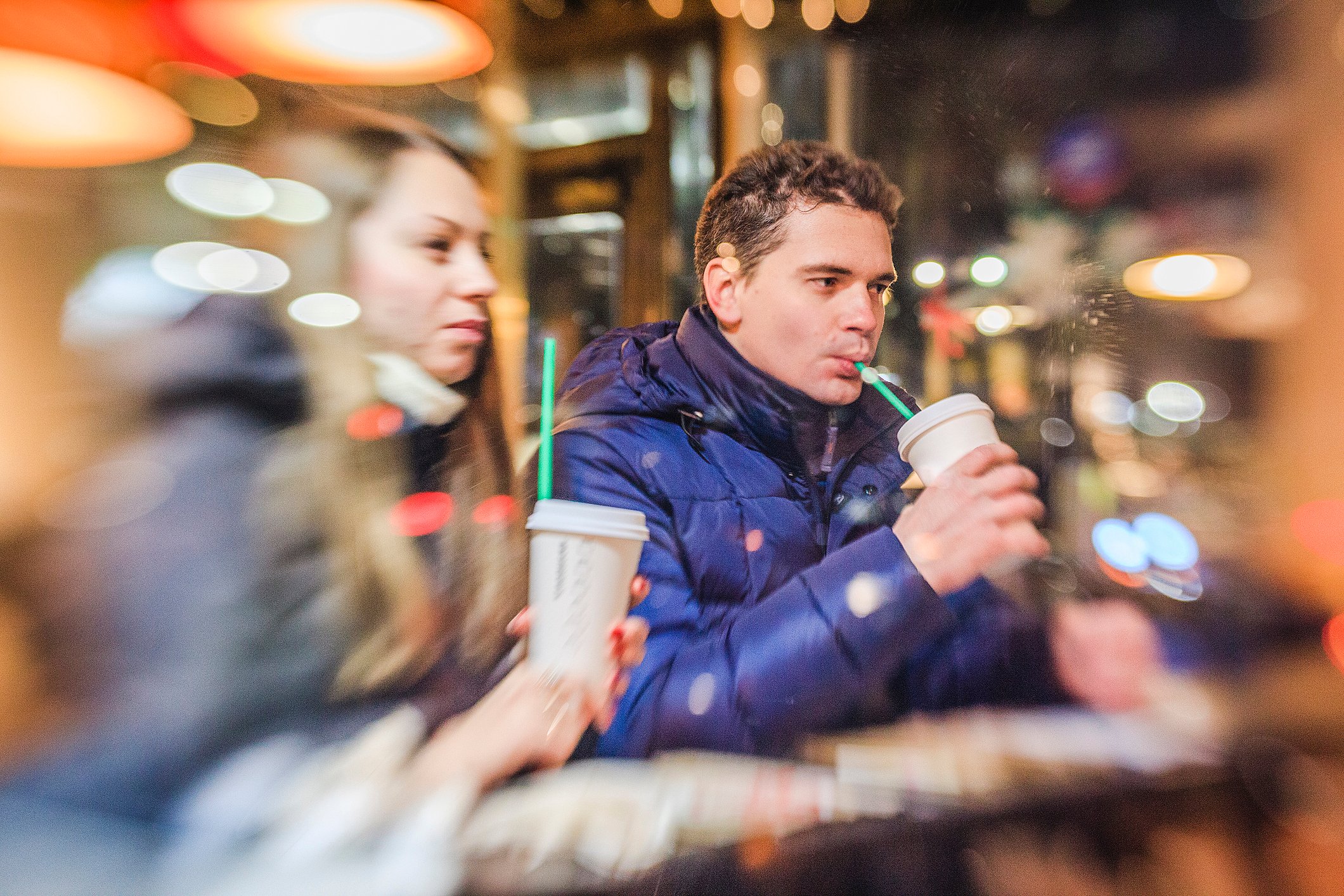 Two people drink coffee in a cafe