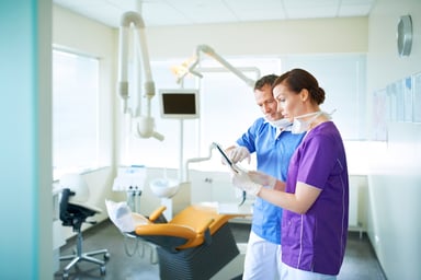 two dentists confer in an office